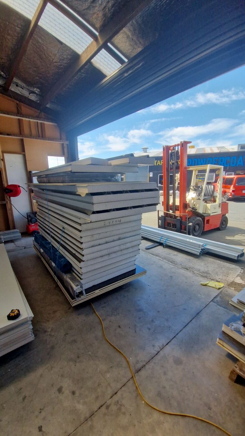 Insulated wall panels stacked and strapped for freight