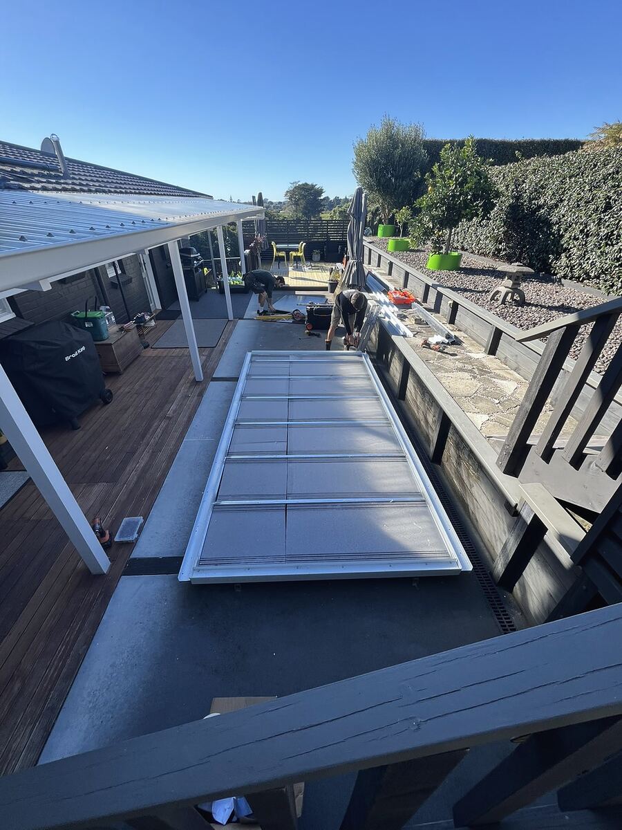 A cabin set in place beside a timber deck, seen from above