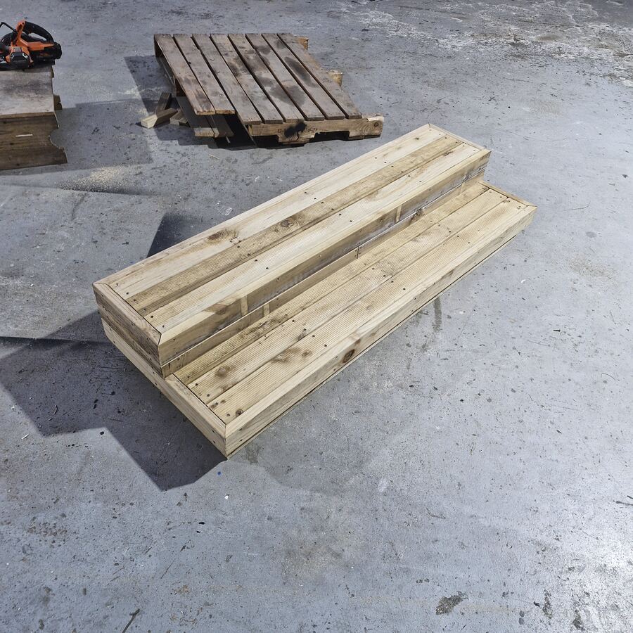 A set of portable timber stairs on the workshop floor